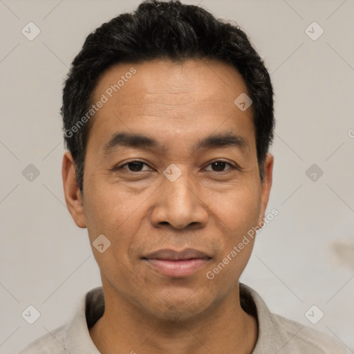 Joyful latino adult male with short  black hair and brown eyes