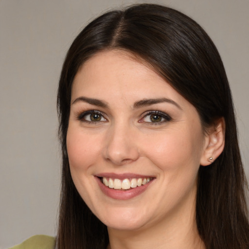 Joyful white young-adult female with long  brown hair and brown eyes