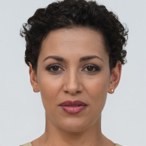 Joyful latino young-adult female with short  brown hair and brown eyes