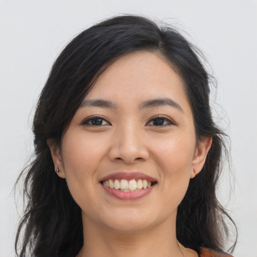 Joyful asian young-adult female with long  brown hair and brown eyes