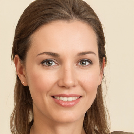 Joyful white young-adult female with long  brown hair and brown eyes