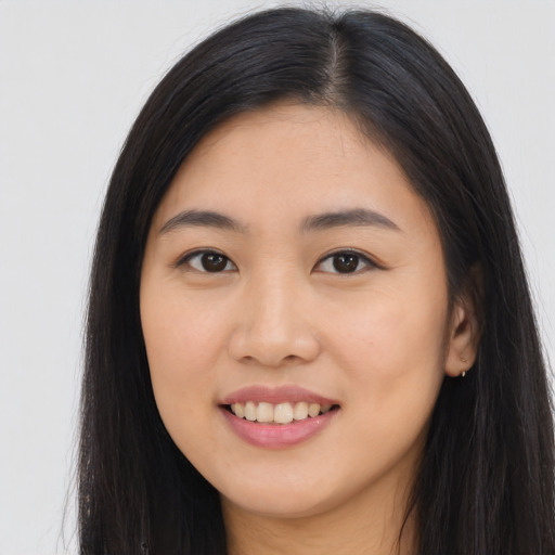Joyful asian young-adult female with long  black hair and brown eyes