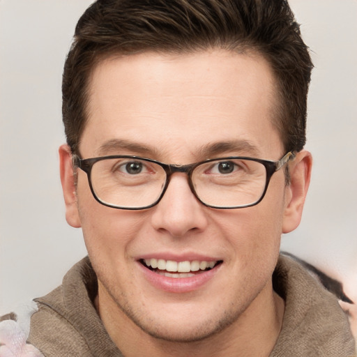 Joyful white young-adult male with short  brown hair and grey eyes