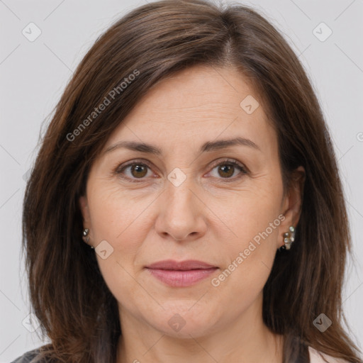 Joyful white adult female with medium  brown hair and brown eyes