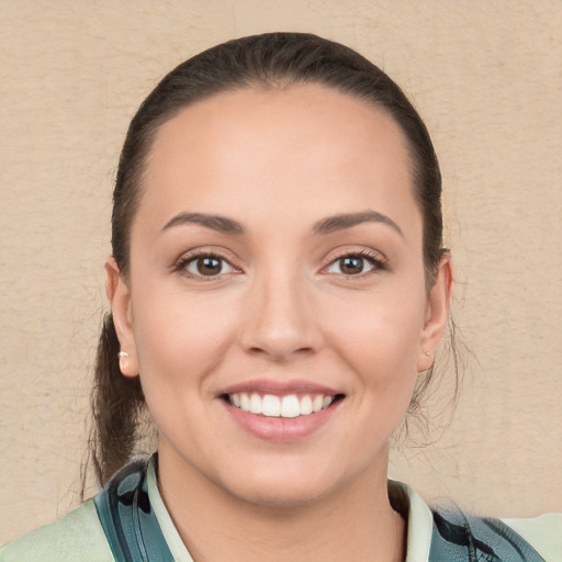 Joyful white young-adult female with medium  brown hair and brown eyes