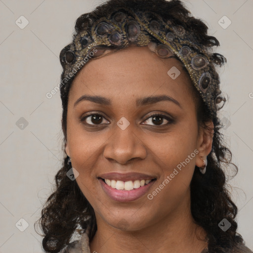 Joyful black young-adult female with long  black hair and brown eyes