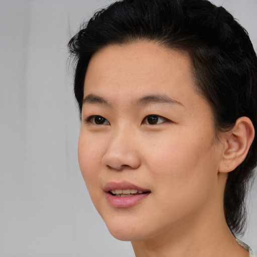 Joyful asian young-adult female with medium  brown hair and brown eyes