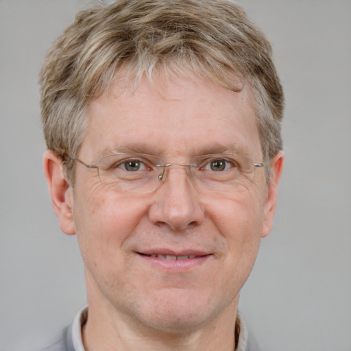 Joyful white adult male with short  brown hair and blue eyes