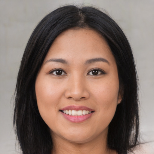 Joyful asian young-adult female with long  black hair and brown eyes