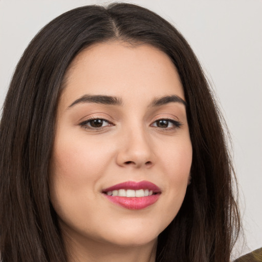 Joyful white young-adult female with long  brown hair and brown eyes