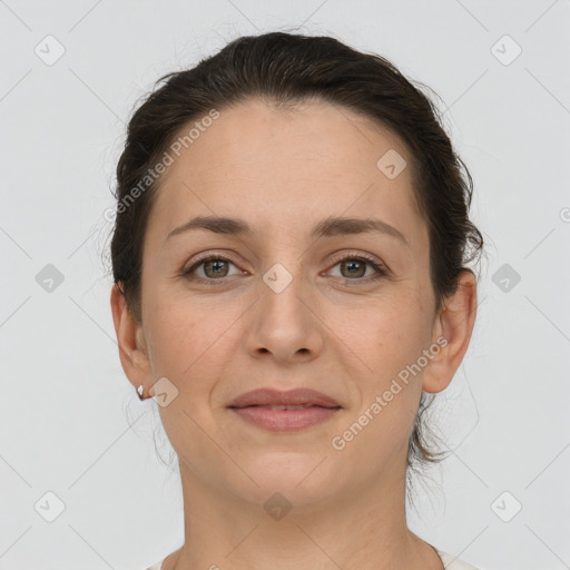 Joyful white young-adult female with short  brown hair and grey eyes