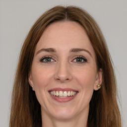 Joyful white young-adult female with long  brown hair and grey eyes