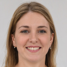 Joyful white young-adult female with long  brown hair and grey eyes