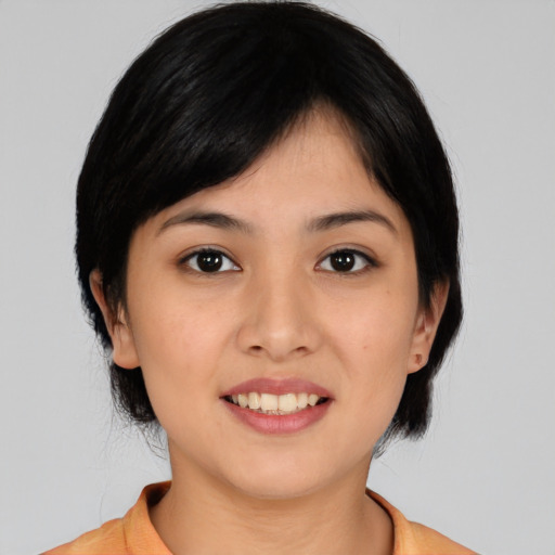 Joyful asian young-adult female with medium  black hair and brown eyes