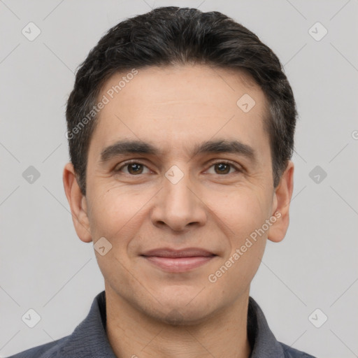 Joyful white young-adult male with short  black hair and brown eyes