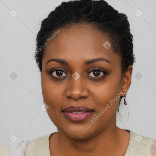 Joyful black young-adult female with short  black hair and brown eyes