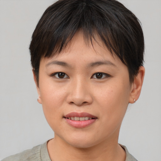 Joyful asian young-adult female with short  brown hair and brown eyes