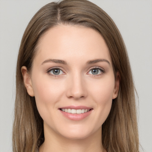 Joyful white young-adult female with long  brown hair and grey eyes