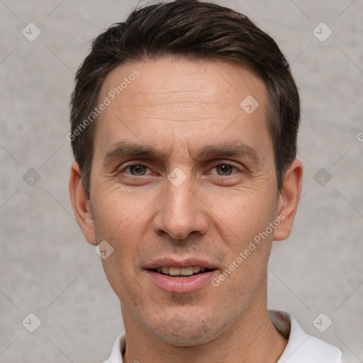 Joyful white adult male with short  brown hair and grey eyes