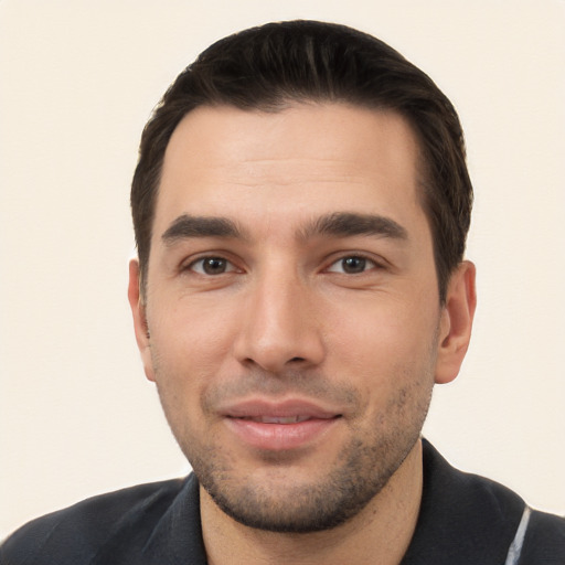 Joyful white young-adult male with short  black hair and brown eyes