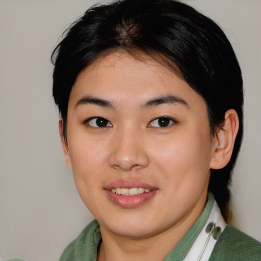 Joyful asian young-adult female with medium  brown hair and brown eyes