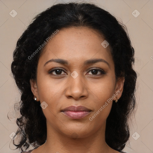 Joyful black young-adult female with long  brown hair and brown eyes