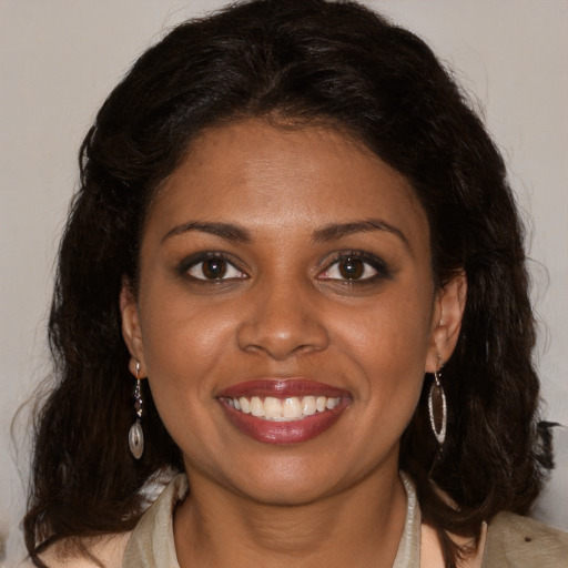 Joyful black young-adult female with medium  brown hair and brown eyes