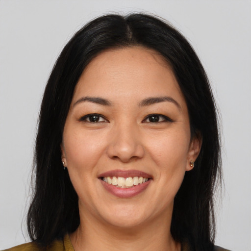 Joyful asian young-adult female with long  brown hair and brown eyes