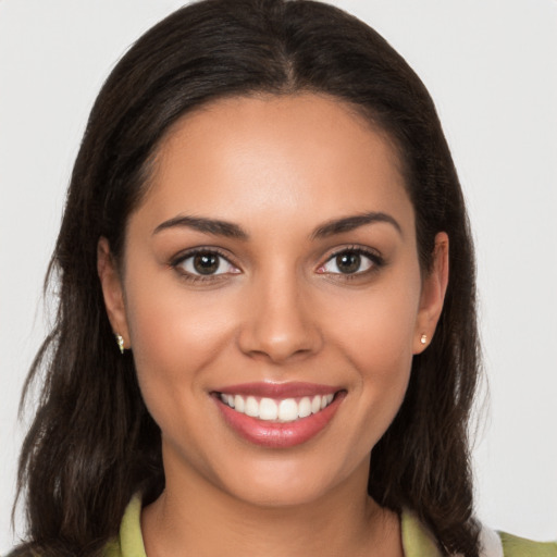 Joyful white young-adult female with long  brown hair and brown eyes