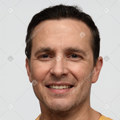 Joyful white adult male with short  brown hair and brown eyes