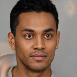 Joyful latino young-adult male with short  brown hair and brown eyes