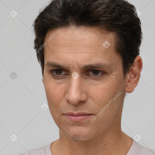 Joyful white adult male with short  brown hair and brown eyes