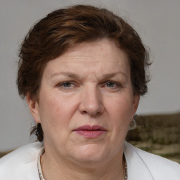 Joyful white adult female with medium  brown hair and blue eyes