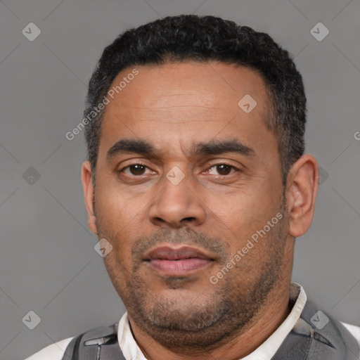 Neutral latino adult male with short  black hair and brown eyes
