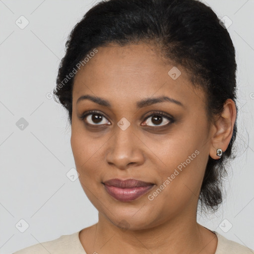 Joyful black young-adult female with short  brown hair and brown eyes