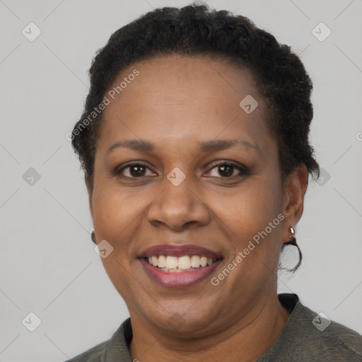 Joyful black adult female with short  brown hair and brown eyes