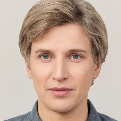 Joyful white adult male with short  brown hair and grey eyes