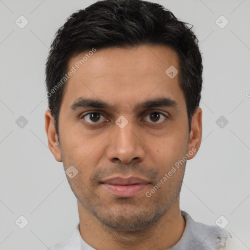 Joyful latino young-adult male with short  black hair and brown eyes