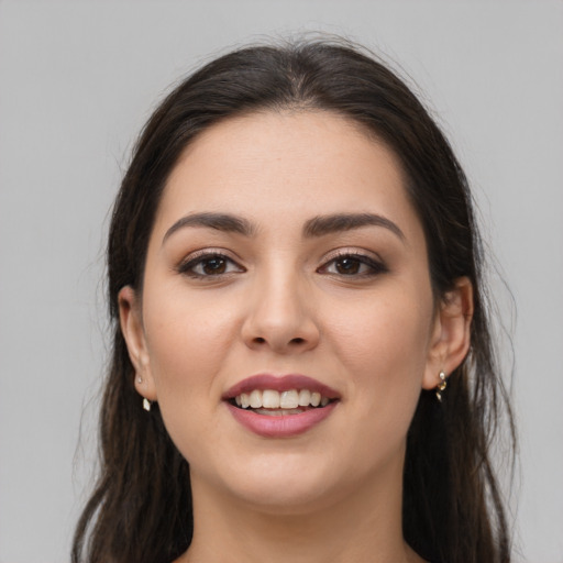 Joyful white young-adult female with long  brown hair and brown eyes