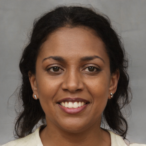 Joyful black young-adult female with medium  brown hair and brown eyes