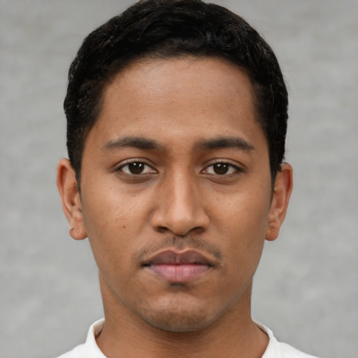 Neutral latino young-adult male with short  black hair and brown eyes