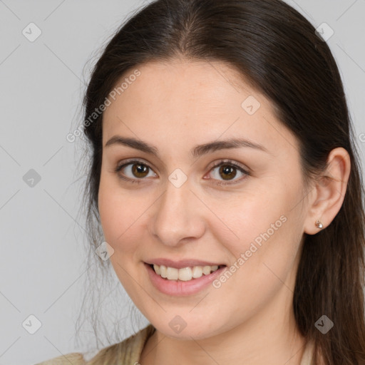 Joyful white young-adult female with long  brown hair and brown eyes