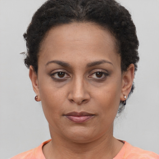 Joyful latino adult female with short  brown hair and brown eyes