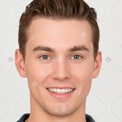 Joyful white young-adult male with short  brown hair and grey eyes