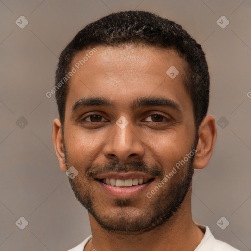 Joyful black young-adult male with short  black hair and brown eyes