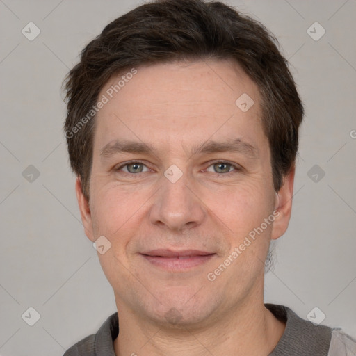 Joyful white adult male with short  brown hair and grey eyes