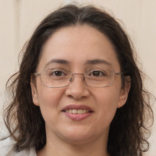 Joyful white adult female with long  brown hair and brown eyes