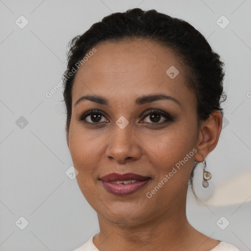 Joyful black young-adult female with short  brown hair and brown eyes