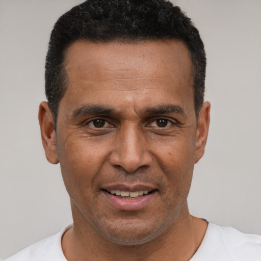Joyful latino adult male with short  black hair and brown eyes