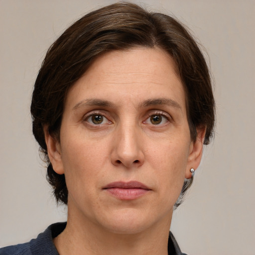 Joyful white adult female with medium  brown hair and grey eyes